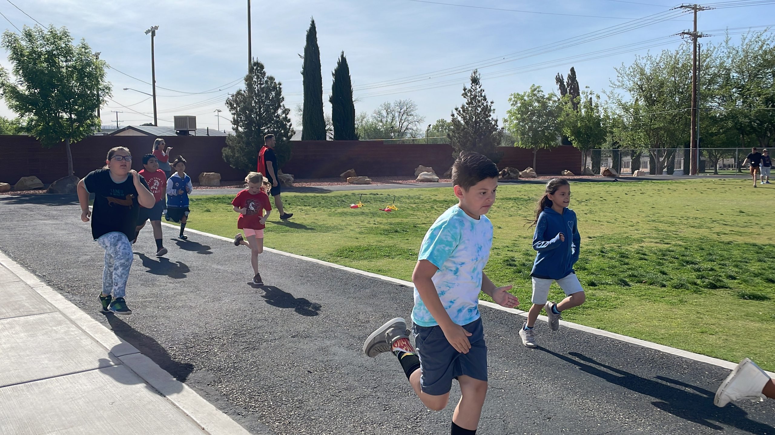 Students run laps to get ready for the IronKids run.