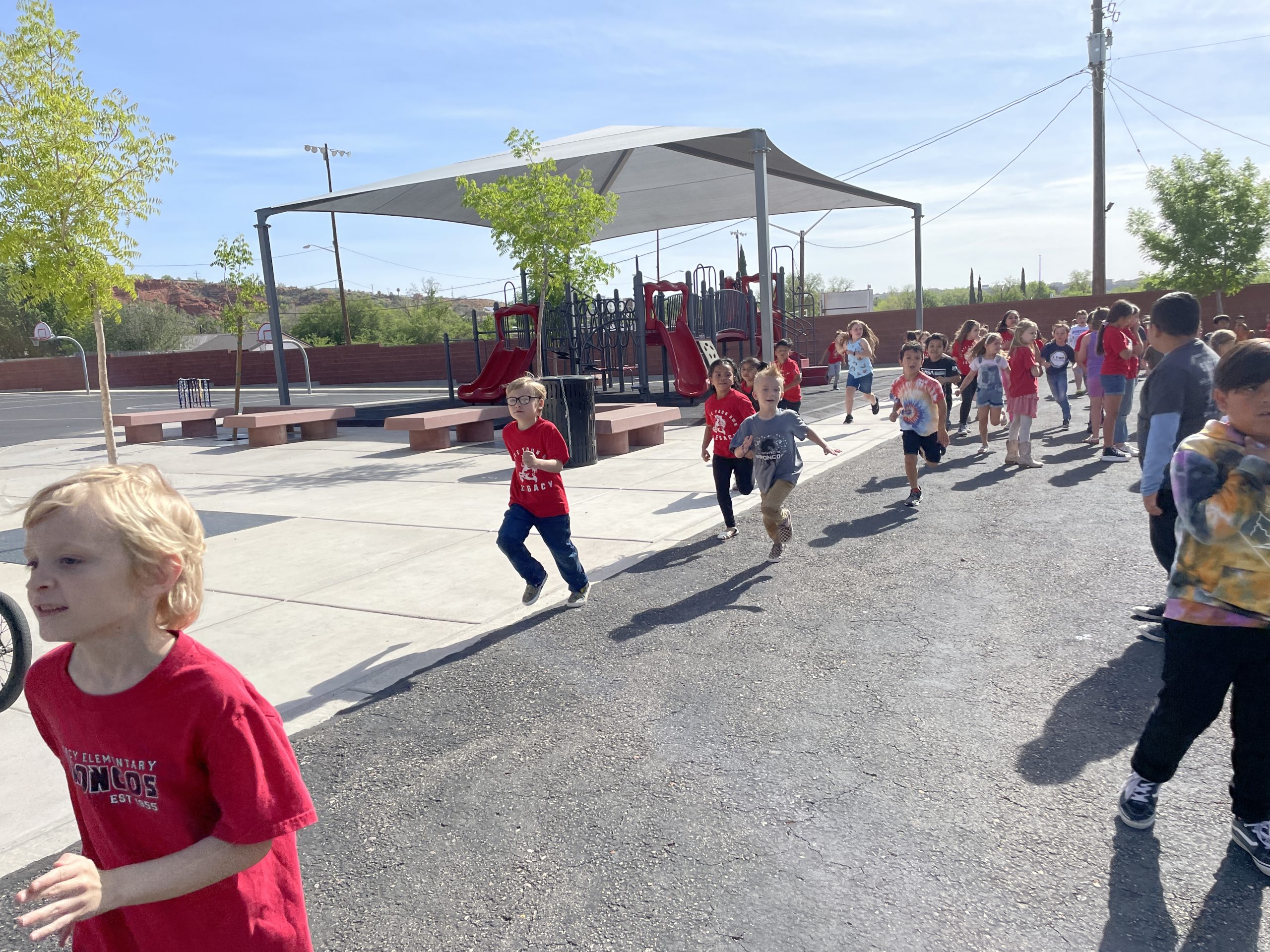 Students run laps to get ready for the IronKids run.